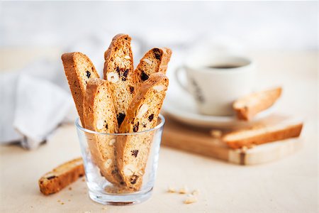 Italian cranberry almond biscotti  and cup of coffee on background Stock Photo - Budget Royalty-Free & Subscription, Code: 400-09131918