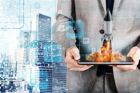 simsearch:400-09112433,k - Businessman launches a fast rocket from a tablet. concept of company startup Stockbilder - Microstock & Abonnement, Bildnummer: 400-09131977