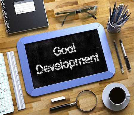 simsearch:400-07338798,k - Small Chalkboard with Goal Development. Top View of Office Desk with Stationery and Blue Small Chalkboard with Business Concept - Goal Development. 3d Rendering. Stock Photo - Budget Royalty-Free & Subscription, Code: 400-09132358