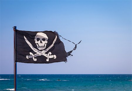 simsearch:400-06084708,k - A damaged pirate flag during a strong windy day, with copyspace Stock Photo - Budget Royalty-Free & Subscription, Code: 400-09132545