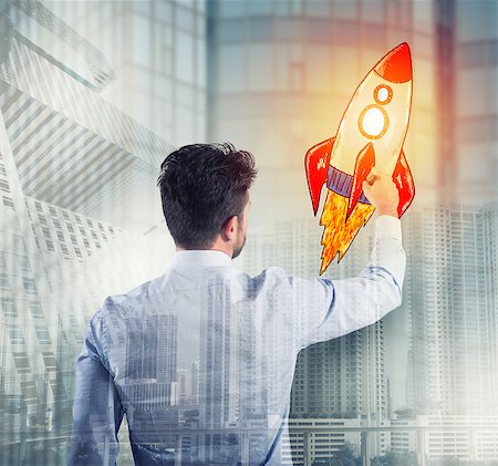 simsearch:400-08575298,k - Businessman drawing a fast rocket. Concept of business improvement and enterprise startup Stock Photo - Budget Royalty-Free & Subscription, Code: 400-09132602