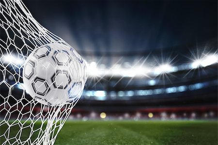 simsearch:400-09032434,k - Soccer ball pierces the soccer goal at the stadium during a night match. 3D Rendering Stockbilder - Microstock & Abonnement, Bildnummer: 400-09132622