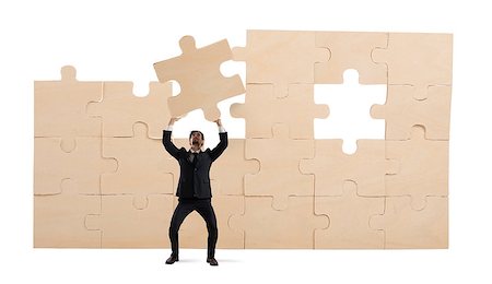 simsearch:400-08668633,k - Businessman holds a piece of puzzle. Build the business concept Stock Photo - Budget Royalty-Free & Subscription, Code: 400-09132673