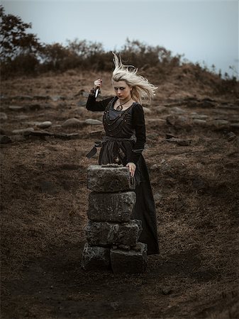 fotolit (artist) - Witch in a long black dress walking through the village in the dark Foto de stock - Royalty-Free Super Valor e Assinatura, Número: 400-09132994