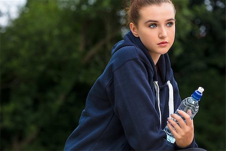 Beautiful sad depressed girl teenager female young woman drinking bottle of water outside Stock Photo - Budget Royalty-Free & Subscription, Code: 400-09141091