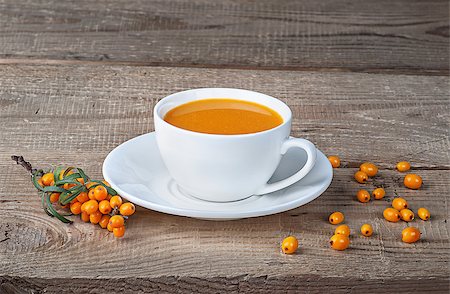 Seabuckthorn juice and berries on wooden table. Sea-buckthorn juice in a white cup on the table. Stock Photo - Budget Royalty-Free & Subscription, Code: 400-09141234
