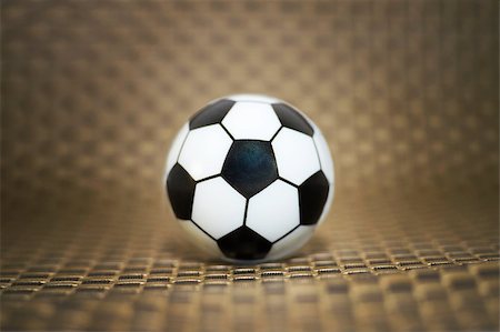 simsearch:400-08372849,k - A toy soccer ball on an artificial background. Concept of the game of football Stock Photo - Budget Royalty-Free & Subscription, Code: 400-09151840