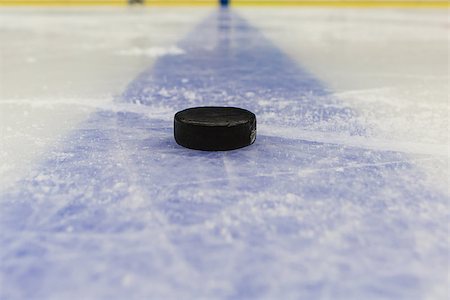 frozen ice background - detail blue line with puck on ice hockey rink Stock Photo - Budget Royalty-Free & Subscription, Code: 400-09170591