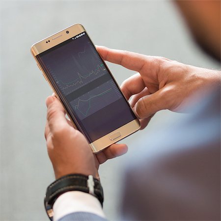 Close up of a businessman using smart phone. Focus on mobile device. Stock Photo - Budget Royalty-Free & Subscription, Code: 400-09170654