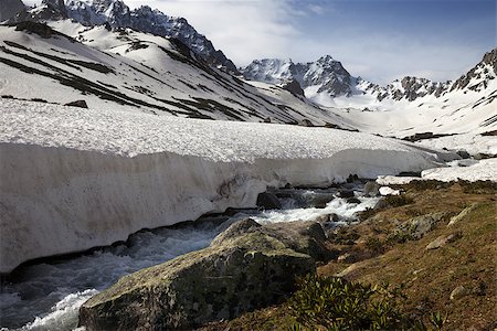 River with snow bridges in spring mountains at sun day. Turkey, Kachkar Mountains (highest part of Pontic Mountains). Stock Photo - Budget Royalty-Free & Subscription, Code: 400-09170662