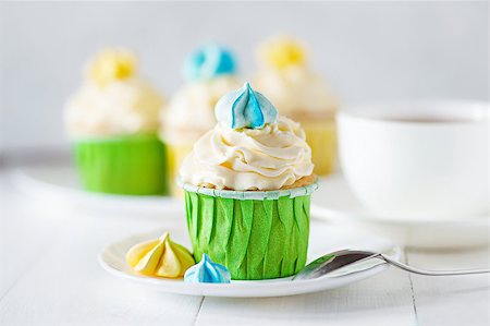 A beautiful bright ladies tea party with cup of tea cupcake with meringues Stock Photo - Budget Royalty-Free & Subscription, Code: 400-09170690