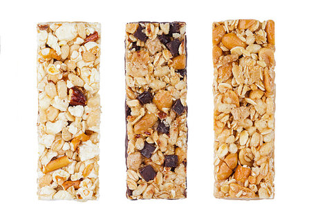 simsearch:400-09238081,k - Protein cereal energy bars with nuts and caramel and chocolate for breakfast on white background Photographie de stock - Aubaine LD & Abonnement, Code: 400-09185914