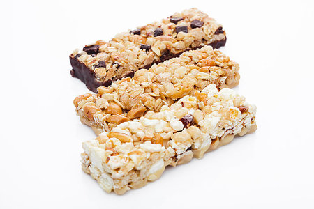 simsearch:400-09238081,k - Protein cereal energy bars with nuts and caramel and chocolate for breakfast on white background Photographie de stock - Aubaine LD & Abonnement, Code: 400-09185956