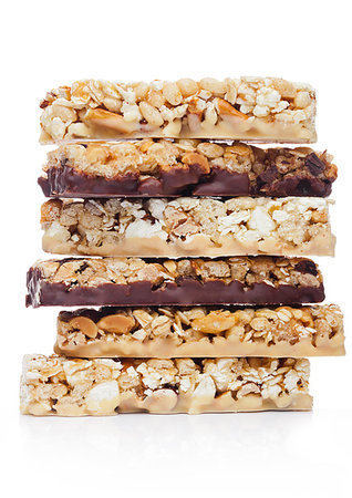 simsearch:400-09238081,k - Protein cereal energy bars with nuts and caramel and chocolate for breakfast on white background Photographie de stock - Aubaine LD & Abonnement, Code: 400-09185958