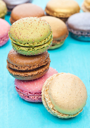 simsearch:400-06564979,k - French luxury colorful macarons dessert cakes on blue wood background with sugar on top Stock Photo - Budget Royalty-Free & Subscription, Code: 400-09185983