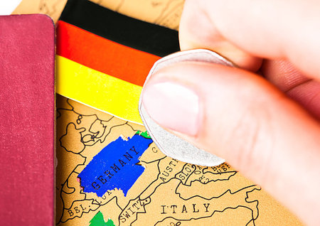 simsearch:400-09186100,k - Travel holiday to Germany concept with passport and flag with female hand choosing Germany on the map Stock Photo - Budget Royalty-Free & Subscription, Code: 400-09186086