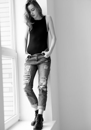 denismart (artist) - Model test with young beautiful fashion model wearing jeans and black shirt standing on window.Black and white Foto de stock - Royalty-Free Super Valor e Assinatura, Número: 400-09186319