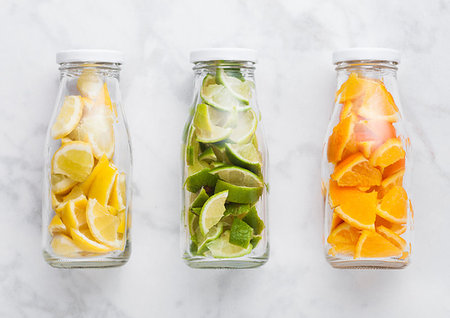 simsearch:400-08012355,k - Bottles of fresh summer water with oranges with limes and lemons slices on marble background Photographie de stock - Aubaine LD & Abonnement, Code: 400-09186329