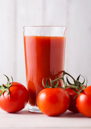 simsearch:400-08977333,k - Glass of fresh organic tomato juice with raw tomatoes on light wooden background Stock Photo - Budget Royalty-Free & Subscription, Code: 400-09186348