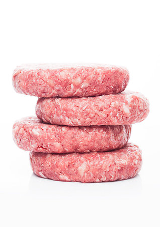 Raw fresh beef burgers on white background with reflection Stock Photo - Budget Royalty-Free & Subscription, Code: 400-09186398