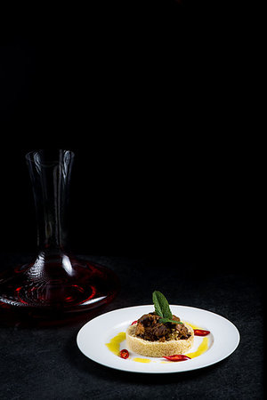 Delicious cooked couscous with meat on a white plate. Good dining at the restaurant Foto de stock - Super Valor sin royalties y Suscripción, Código: 400-09224820