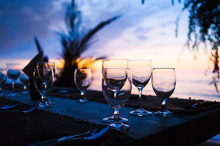 Glasses on table in tropical restaurant at sunset or sunrise Stock Photo - Budget Royalty-Free & Subscription, Code: 400-09224979