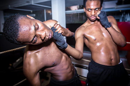 simsearch:642-01737144,k - African American quick fighter punching in the chin his opponent during MMA fight Stock Photo - Budget Royalty-Free & Subscription, Code: 400-09224980