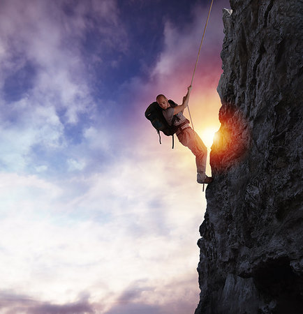 simsearch:400-09273583,k - Explorer man climbs a high danger mountain with a rope during sunset Stockbilder - Microstock & Abonnement, Bildnummer: 400-09225508