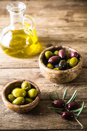 simsearch:400-05666507,k - olives on olive branch. Wooden table with olives and olive oil Stock Photo - Budget Royalty-Free & Subscription, Code: 400-09225967