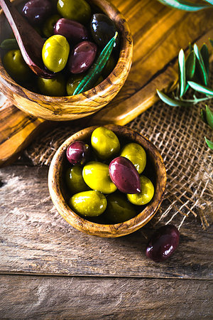 simsearch:400-05666507,k - olives on olive branch. Wooden table with olives in bowl Stock Photo - Budget Royalty-Free & Subscription, Code: 400-09220860