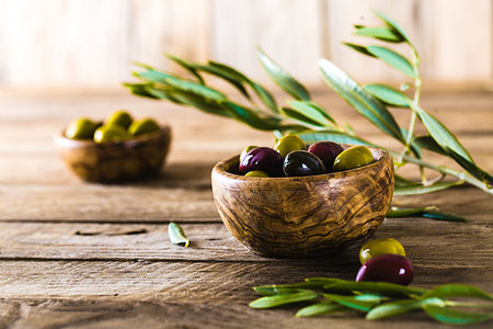 simsearch:400-05666507,k - olives on olive branch. Wooden table with olives in bowl Stock Photo - Budget Royalty-Free & Subscription, Code: 400-09220861