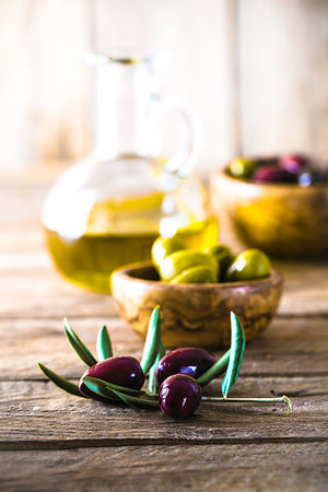 simsearch:400-05666507,k - olives on olive branch. Wooden table with olives and olive oil Stock Photo - Budget Royalty-Free & Subscription, Code: 400-09220863