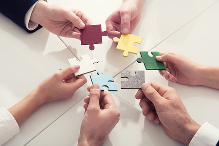 Businessmen working together to build a colored puzzle. Concept of teamwork, partnership, integration and startup. Stock Photo - Budget Royalty-Free & Subscription, Code: 400-09221113
