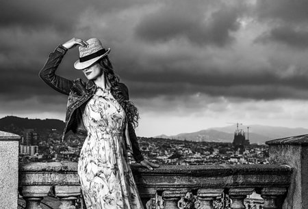 simsearch:400-08415527,k - Perfect evening with stunning view. stylish traveller woman in long dress and straw hat against city panorama of Barcelona, Spain posing Stock Photo - Budget Royalty-Free & Subscription, Code: 400-09221254