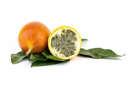 passiflora - whole grenadilla yellow passion fruit half of the fruit with a juicy filling with many seeds Stock Photo - Budget Royalty-Free & Subscription, Code: 400-09221679