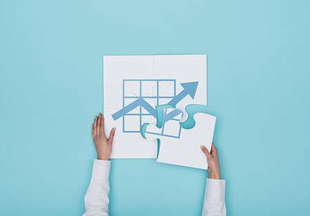 Woman completing a puzzle with a financial graph icon, she is putting the missing piece, finance and business solutions concept Stock Photo - Budget Royalty-Free & Subscription, Code: 400-09221745