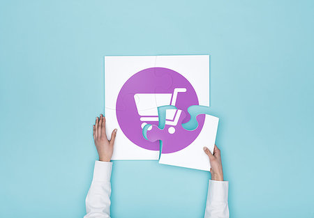 Woman completing a puzzle with a shopping cart icon, she is putting the missing piece, shopping and retail concept Stock Photo - Budget Royalty-Free & Subscription, Code: 400-09221747