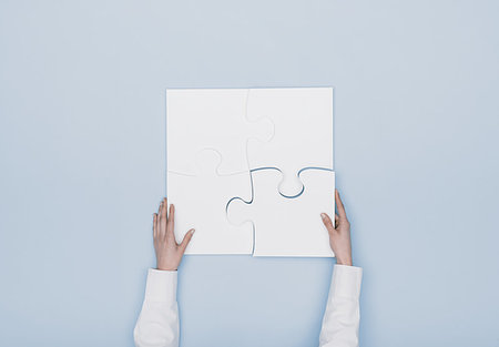 Woman assembling a jigsaw puzzle she is adding the last missing piece, solutions and challenges concept Stock Photo - Budget Royalty-Free & Subscription, Code: 400-09221748
