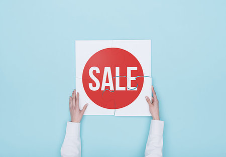 Woman completing a puzzle with a sale badge, she is putting the missing piece, shopping and offers concept Stock Photo - Budget Royalty-Free & Subscription, Code: 400-09221750