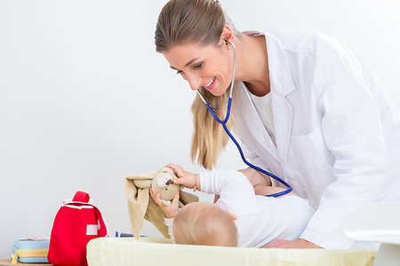 simsearch:400-08935984,k - Dedicated female pediatrician using the stethoscope during the routine medical check-up of a cute and healthy baby girl in a modern healthcare center Stock Photo - Budget Royalty-Free & Subscription, Code: 400-09221802