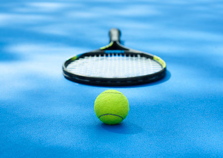 simsearch:400-08755898,k - Yellow tennis ball is laying near professional racket on blue cort carpet. Made for playing tennis. Contrast image with satureted colors and shadows. Concept of sport equipment photo. Stock Photo - Budget Royalty-Free & Subscription, Code: 400-09221990