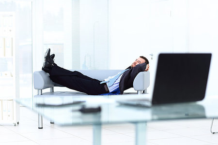 Portrait of happy businessman relaxing in white office Photographie de stock - Aubaine LD & Abonnement, Code: 400-09222128