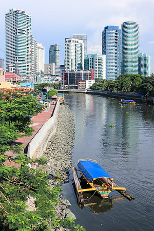 MANILA - JUNE 12: Small passenger ferry boats crossing the pasig river from  makati to highrise Rockwell district on June 12 2014  in Manila. The 25 kilometre Pasig River connects Laguna de Bay to Manila Bay. Stock Photo - Budget Royalty-Free & Subscription, Code: 400-09222132