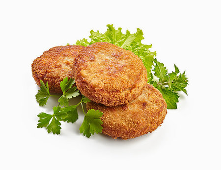 simsearch:400-07478286,k - Three fried breaded cutlet with lettuce and parsley isolated on white background Stock Photo - Budget Royalty-Free & Subscription, Code: 400-09222163