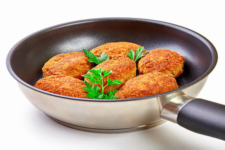 Cooked fried cutlets in pan isolated on white background, top view Stock Photo - Budget Royalty-Free & Subscription, Code: 400-09222300