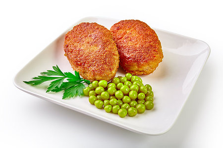 Two fried breaded cutlet with lettuce and parsley isolated on white background Stock Photo - Budget Royalty-Free & Subscription, Code: 400-09222301