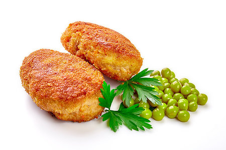 Two fried breaded cutlet with lettuce and parsley isolated on white background Stock Photo - Budget Royalty-Free & Subscription, Code: 400-09222302