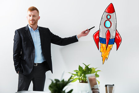 simsearch:400-08575298,k - Businessman drawing a fast rocket. Concept of business improvement and enterprise startup Stock Photo - Budget Royalty-Free & Subscription, Code: 400-09222313