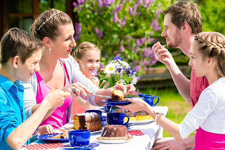 family tea time - Happy family having coffee time in garden eating cake Stock Photo - Budget Royalty-Free & Subscription, Code: 400-09222457