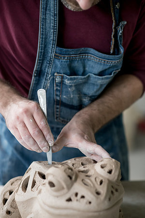 pottery sculpt - Ceramist Dressed in an Apron Sculpting Statue from Raw Clay in the Bright Ceramic Workshop. Stock Photo - Budget Royalty-Free & Subscription, Code: 400-09222535